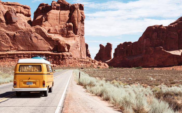 Yellow Volkswagen van on road in desert