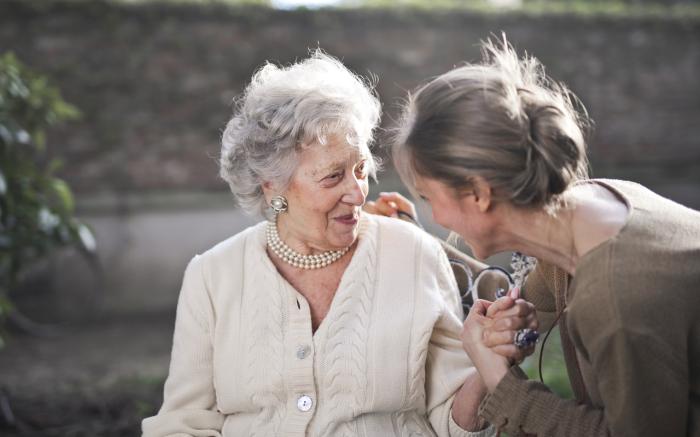 Elderly woman and younger woman having a conversation