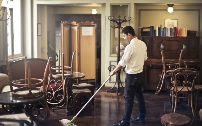 Man cleaning floor in restaurant